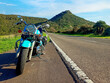 Frontal view of a classic motorcycle on the edge of a country road