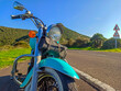 Front view of a classic motorcycle on the edge of a country road