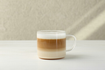 Poster - Aromatic coffee in glass cup on white wooden table