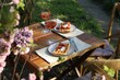 Delicious Belgian waffles with fresh strawberries and wine served on table in spring garden