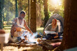 Young happy couple camping in forest.
