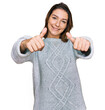 © Krakenimages.com - Young caucasian girl wearing casual clothes approving doing positive gesture with hand, thumbs up smiling and happy for success. winner gesture.