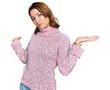 © Krakenimages.com - Young caucasian girl wearing wool winter sweater clueless and confused expression with arms and hands raised. doubt concept.