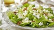 A delectable salad featuring fresh green apples, crumbled feta cheese, and crunchy walnuts rests on a lettuce bed, elegantly presented on a white tablecloth.