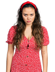 Poster - Young hispanic girl wearing casual clothes skeptic and nervous, frowning upset because of problem. negative person.