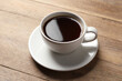 Cup of aromatic coffee on wooden table
