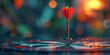 Darts target with arrow hit in the center on blurred bokeh background