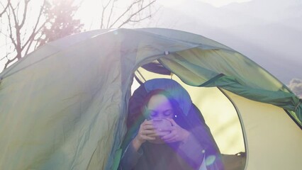 Sticker - child sits in a tent and has breakfast. tent against the backdrop of the mountains. boy on a hike. boy in a sleeping bag with a plate in his hands. camping and trekking with children.