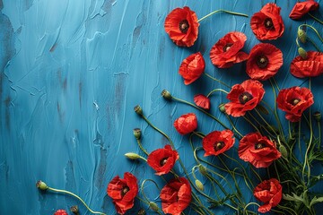 Wall Mural - red poppies flowers border frame on blue painted background top view, beautiful floral template with copy space