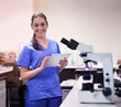 Portrait, female scientist and microscope in laboratory for research or medical breakthrough. Health, smile and notes with nurse or assistant with equipment for clinical trial in America with report.