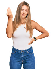 Canvas Print - Young blonde woman wearing casual style with sleeveless shirt doing italian gesture with hand and fingers confident expression