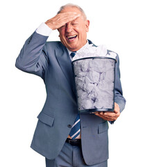 Canvas Print - Senior handsome grey-haired man holding paper bin with crumpled document stressed and frustrated with hand on head, surprised and angry face