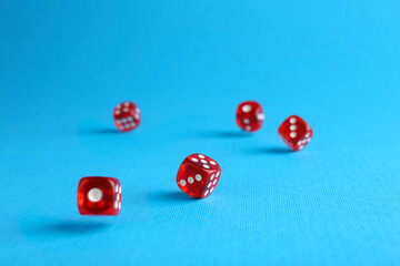 Sticker - Many red game dices falling on light blue background