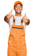 © Krakenimages.com - Young handsome african american man wearing handyman uniform approving doing positive gesture with hand, thumbs up smiling and happy for success. winner gesture.
