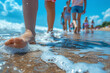 © SnapVault - Ground-level view capturing a child's bare foot stepping into the soft, foamy ocean water on a sandy beach in summer.