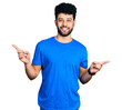 © Krakenimages.com - Young arab man with beard wearing casual blue t shirt smiling confident pointing with fingers to different directions. copy space for advertisement