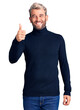© Krakenimages.com - Young handsome blond man wearing casual turtleneck sweater smiling happy and positive, thumb up doing excellent and approval sign