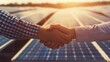 Firm representatives engage in a handshake before an expanse of solar panels, signifying alliances fostered for green initiatives. Corporate carbon reduction