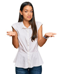 Sticker - Beautiful hispanic woman wearing casual clothes clueless and confused expression with arms and hands raised. doubt concept.