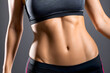 © Ocharonata - female flat athletic belly with abs in black sportswear on dark background