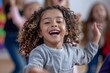 © Maelgoa - Happy children dancing and singing along to music in a music class