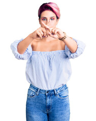 Poster - Young beautiful woman with pink hair wearing casual clothes rejection expression crossing fingers doing negative sign