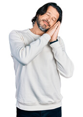 Canvas Print - Middle age caucasian man wearing casual clothes sleeping tired dreaming and posing with hands together while smiling with closed eyes.