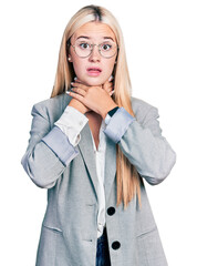 Beautiful blonde woman wearing business jacket and glasses shouting and suffocate because painful strangle. health problem. asphyxiate and suicide concept.