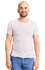 Wall Mural - Young handsome man wearing casual t shirt with a happy and cool smile on face. lucky person.