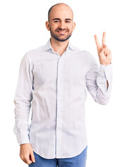 Sticker - Young handsome man wearing elegant shirt smiling with happy face winking at the camera doing victory sign. number two.