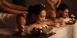 © Pixel-Shot - Young couple getting massage in dark spa salon