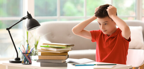 Canvas Print - Stressed little boy doing lessons at home