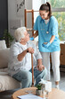 © Pixel-Shot - Nurse showing mobile phone to senior man with stick at home