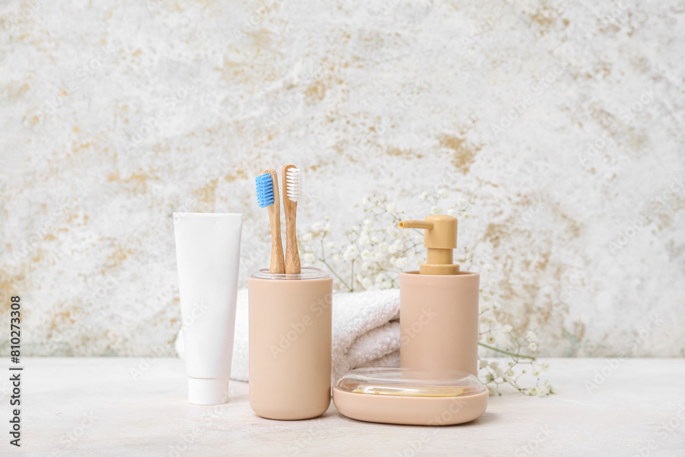 Set of bath supplies with bamboo toothbrushes on light background