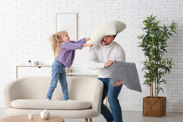 Poster - Emotional father with his cute little daughter fighting pillows at home