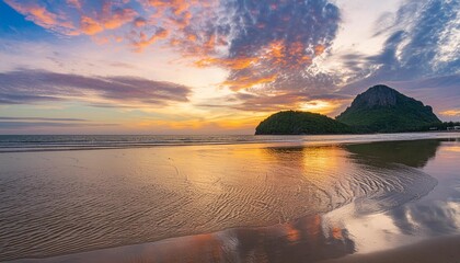 Wall Mural - natural background of the colorful sky and beautiful water reflection during sunset at mae ramphueng beach prachuap khiri khan province in thailand