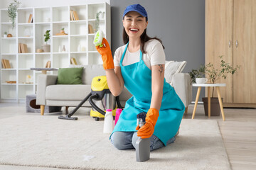 Wall Mural - Female janitor cleaning carpet with brush in room