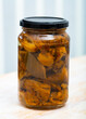 Close-up of delicious marinated milk fungus mushrooms at glass jar