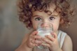 Curly child drinking milk, close-up