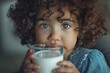 Curly-haired child drinking milk