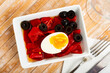 Stewed sweet red peppers with boiled egg and olives