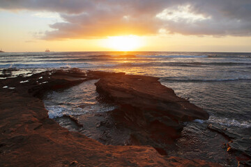 Wall Mural - Ocean sunset view from rocky shoreline