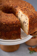 Pecan caramel pound cake baked in a bundt pan served on a cake stand