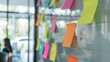 © Jaroon - Business team brainstorms together using sticky notes on a whiteboard.