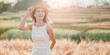 © Satori Studio - Carefree young woman in a summer dress and straw hat enjoying the golden glow of the sunset in a beautiful wheat field.