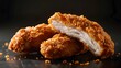 © horizon - Chicken fingers against a black background, with one piece cut in half to reveal the interior texture. The bright and natural lighting highlights the golden brown coloring and soft textures.
