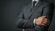 © kitidach - Illustrate a male executive in a dark grey suit, torso showing, with one hand gently touching the opposite arm