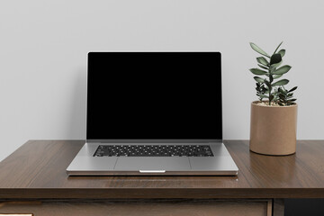 Wall Mural - Front view of blank screen laptop on wooden table. 3d rendering