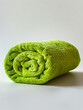 A green towel folded on top of itself.