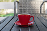 Fototapeta Natura - Cup of coffee on a table in the patio.	
